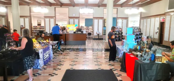 Photo from the Joliet Public Library during the Fandom, Art, and Music Expo 2026 showing many tables from local artists and creators.